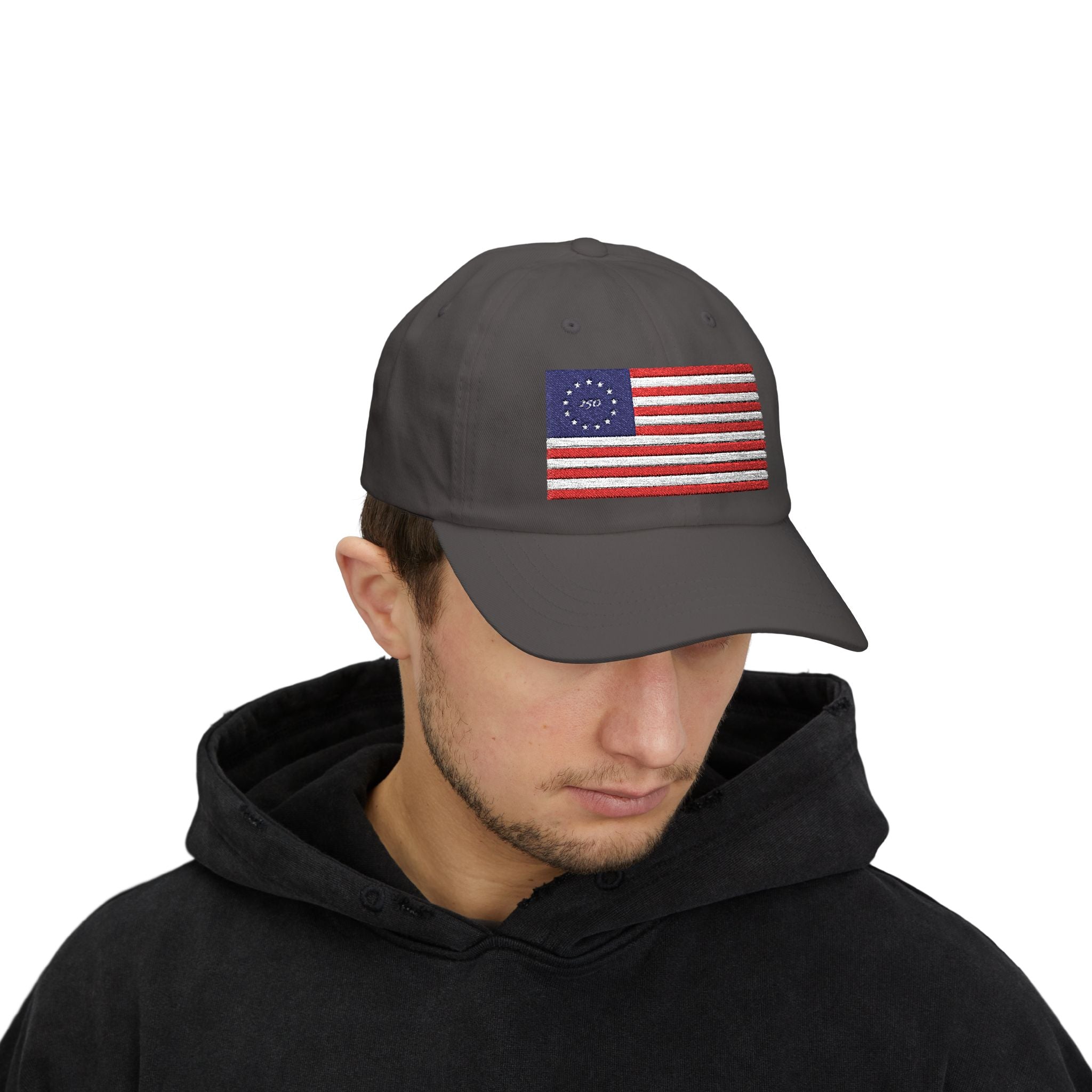 Man wearing dark grey dad cap embroidered with Betsy Ross Flag