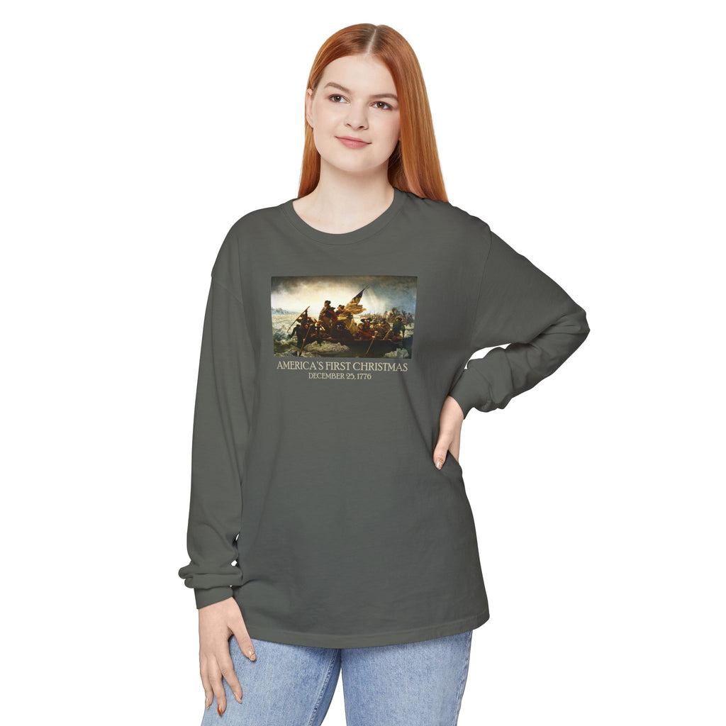 Woman wearing a long-sleeve Pepper Comfort Colors t-shirt with Leutze's 'Washington Crossing the Delaware' with 'America's First Christmas December 25, 1776 printed below