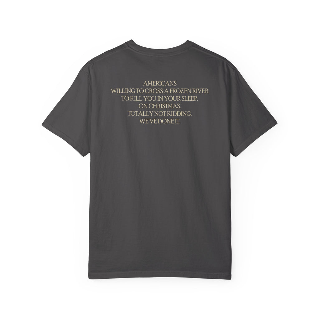 Back of America's First Christmas meme t-shirt with 'AMERICANS Willing to cross a frozen river to kill you in your sleep. On Christmas.' quote in Graphite