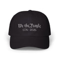 Black cap with embroidered 'We the People 1776-2026' against a white background
