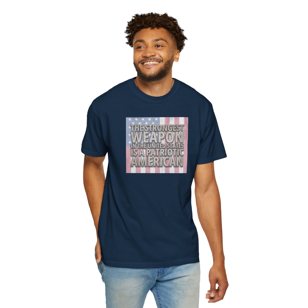 Smiling man wearing 'The Strongest Weapon in the United States is a Patriotic American' t-shirt in true navy