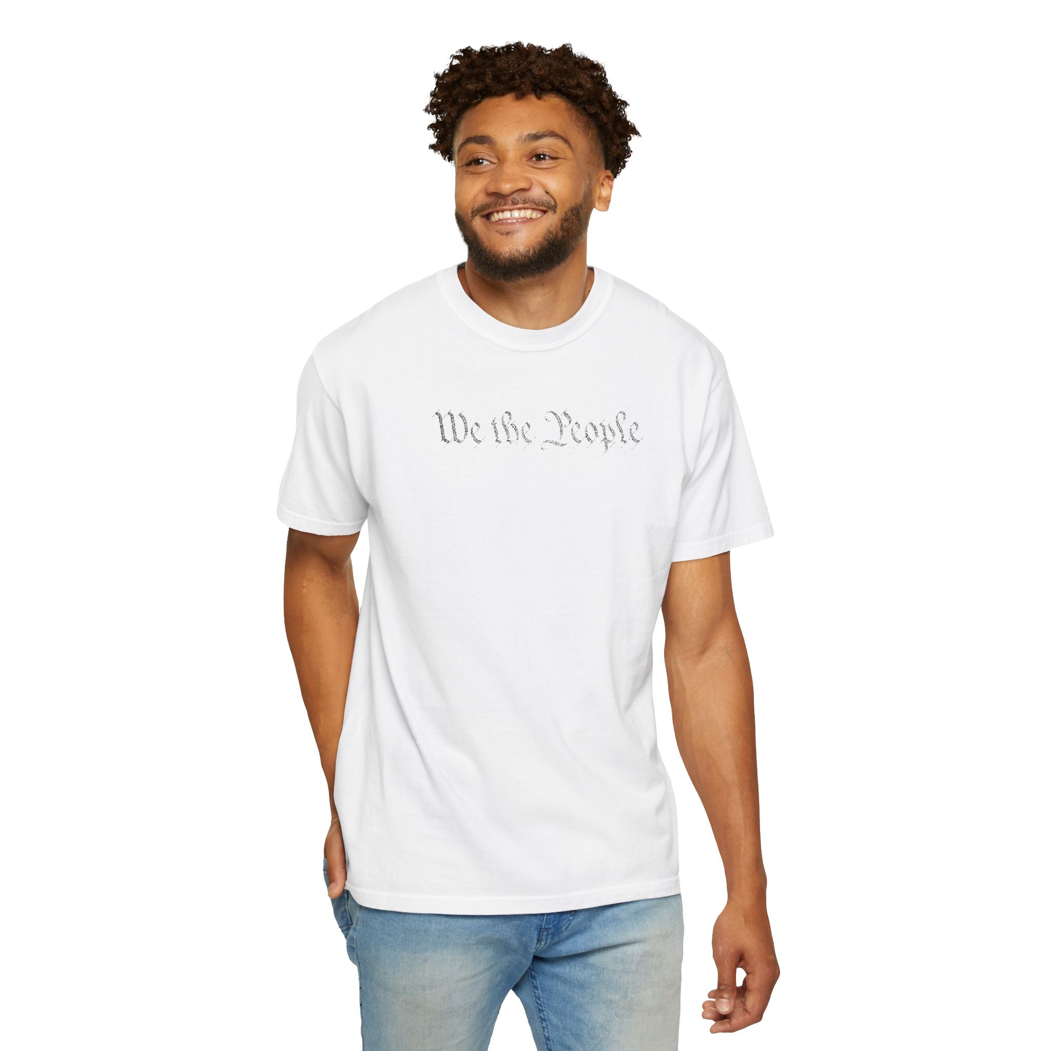 Smiling man wearing 'We the People' embroidered t-shirt in white