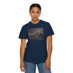 Woman wearing a True Navy Comfort Colors t-shirt with a printed design of Trumbull's  'Declaration of Independence' painting with '1776-2026' in overlapping revolutionary era text