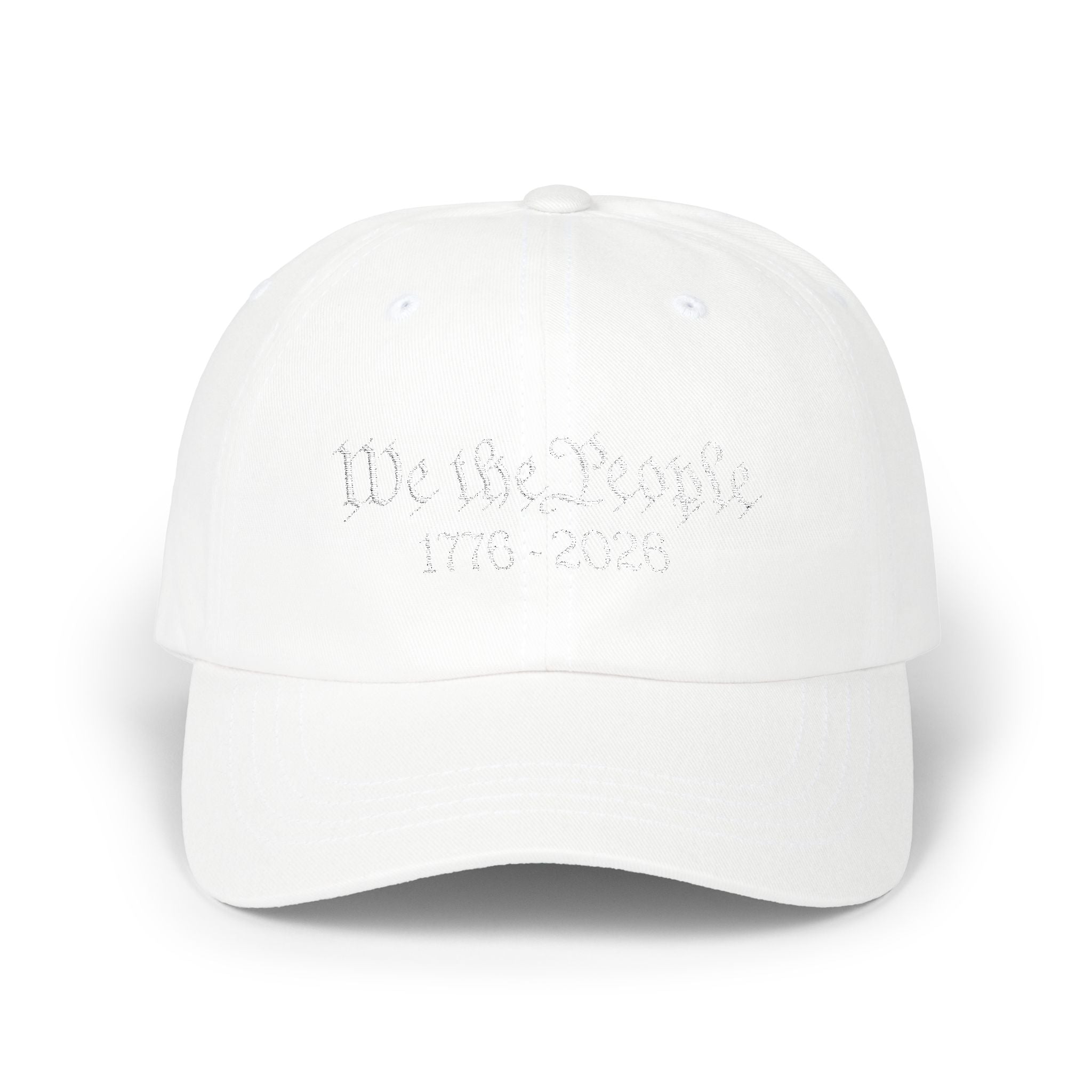 White cap with 'We the People 1776-2026' embroidery against on a white background