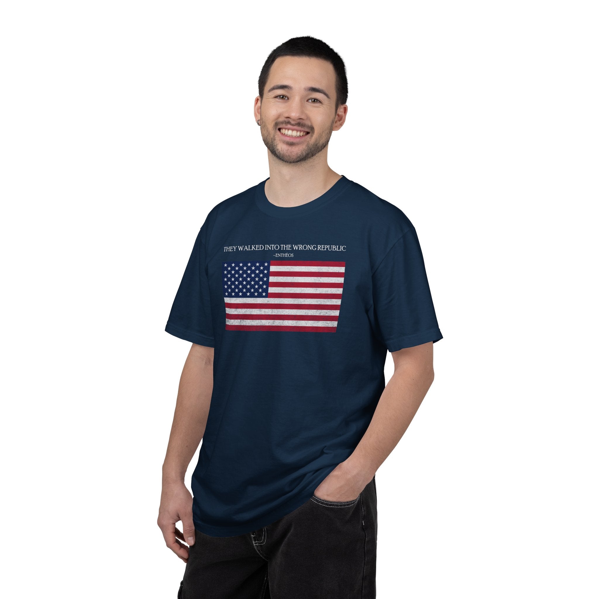 Smiling man wearing a True Navy Comfort Colors t-shirt with distressed American flag graphic and 'They Walked Into the Wrong Republic' quote from Entheos