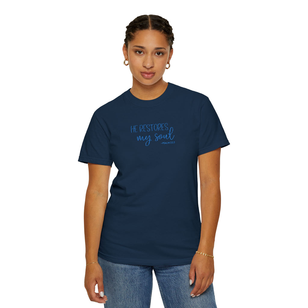 Woman wearing True Navy Comfort Colors t-shirt with 'He restores my soul' embroidered in cornflower blue thread