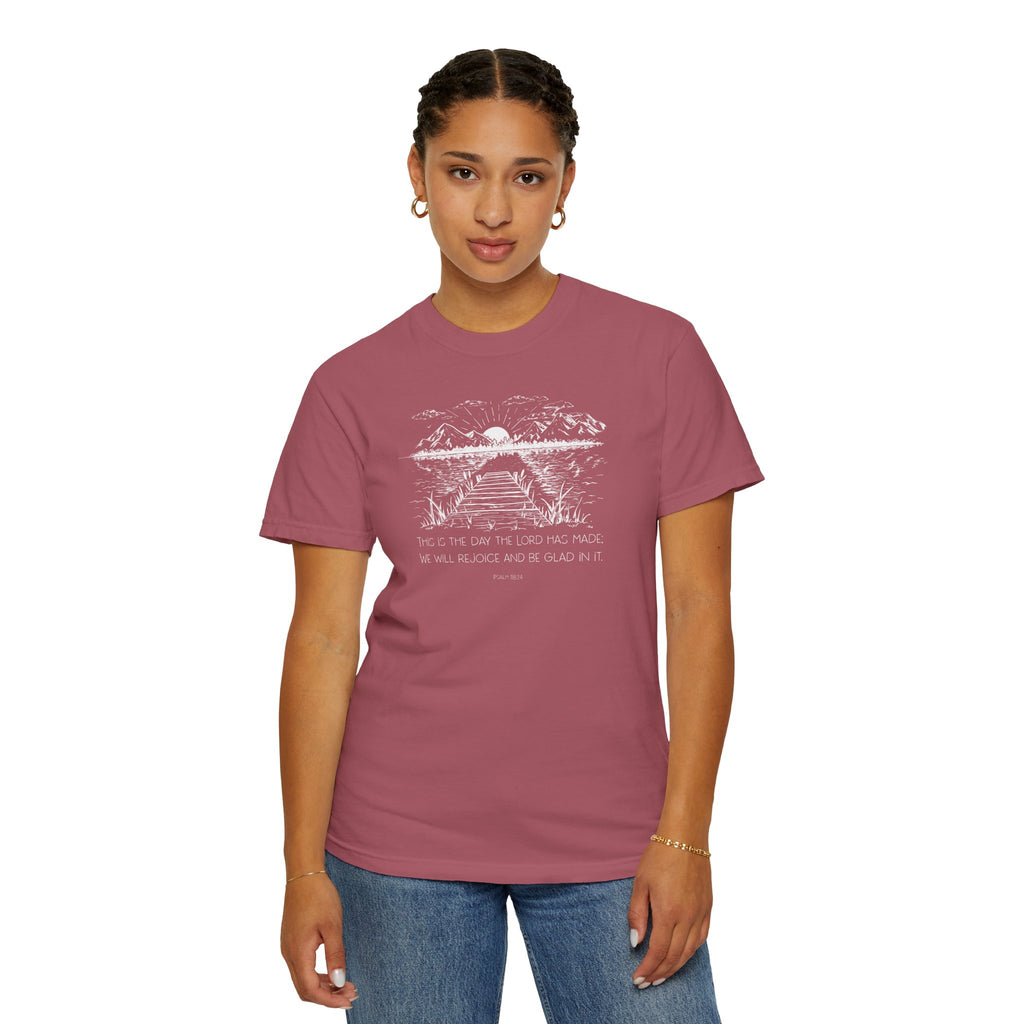 Woman wearing Crimson Comfort Colors t-shirt with nature graphic and 'This is the day the Lord has made; We will rejoice and be glad in it' below