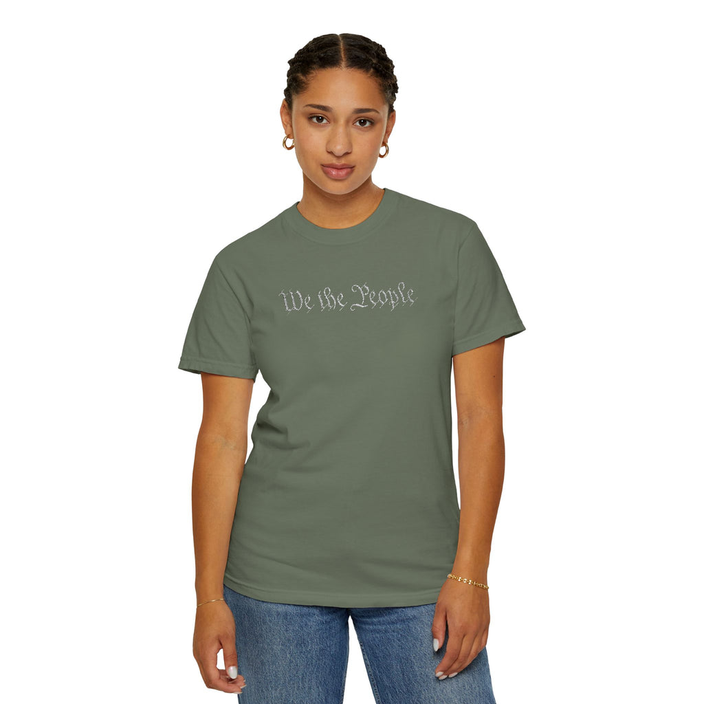 Woman wearing 'We the People' embroidered t-shirt in moss