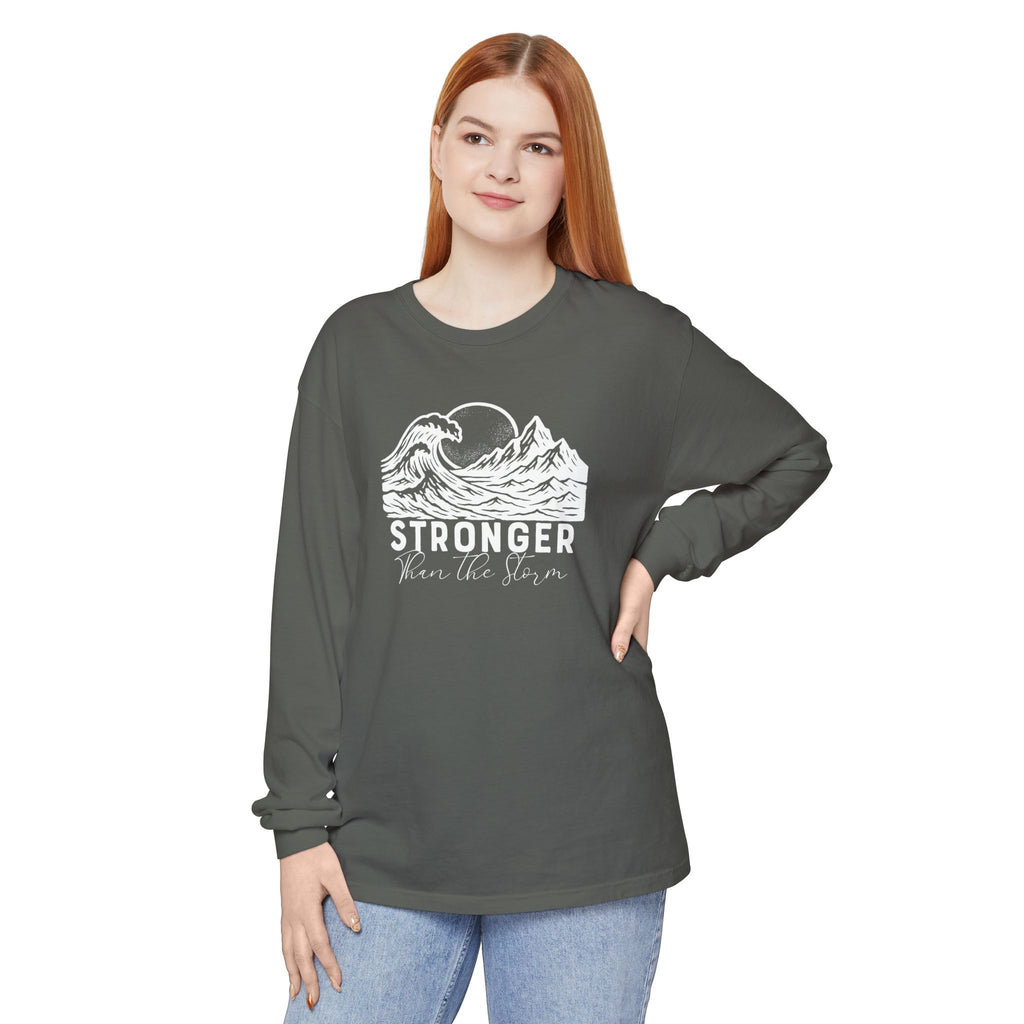 Person wearing Stronger Than The Storm faith long sleeve t-shirt in pepper