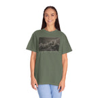 Woman wearing an oversized Moss Comfort Colors t-shirt with a printed design of Trumbull's  'Declaration of Independence' painting with '1776-2026' in overlapping revolutionary era text
