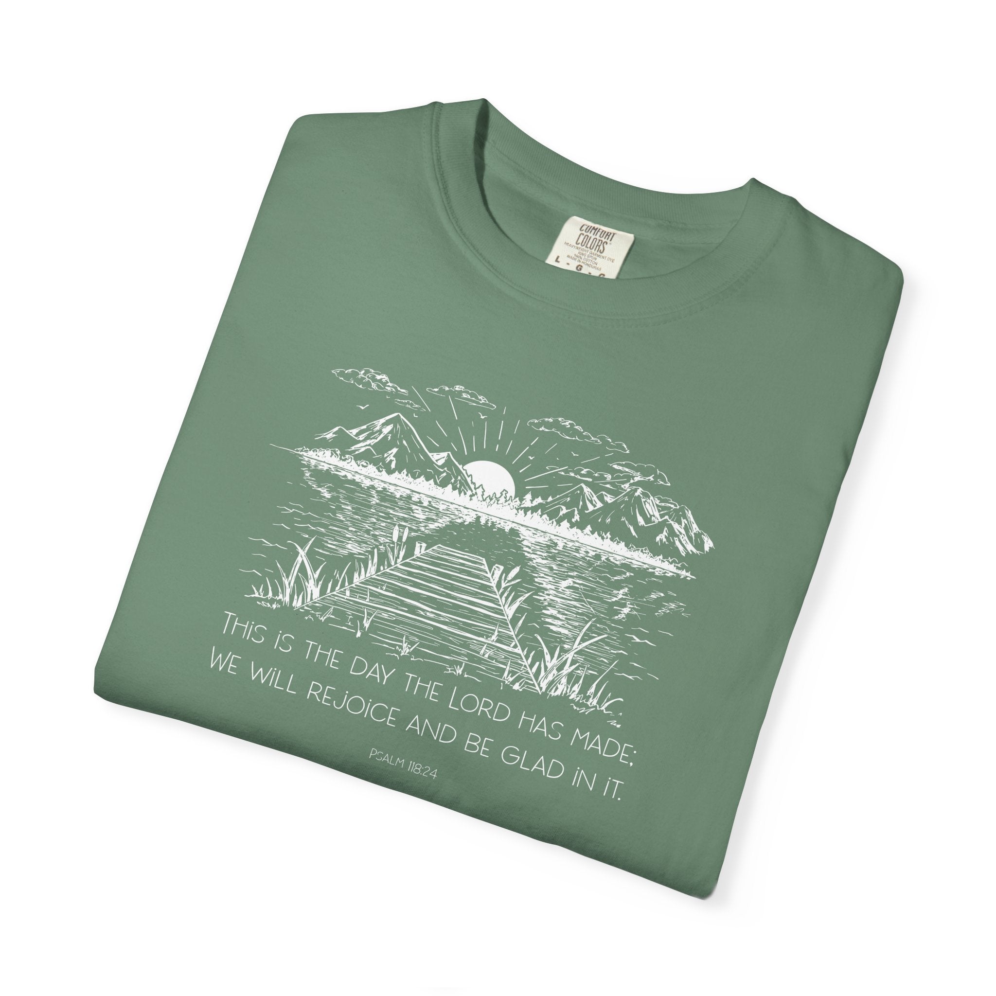 Folded Light Green Comfort Colors t-shirt with nature graphic and Psalm 118:24 beneath it