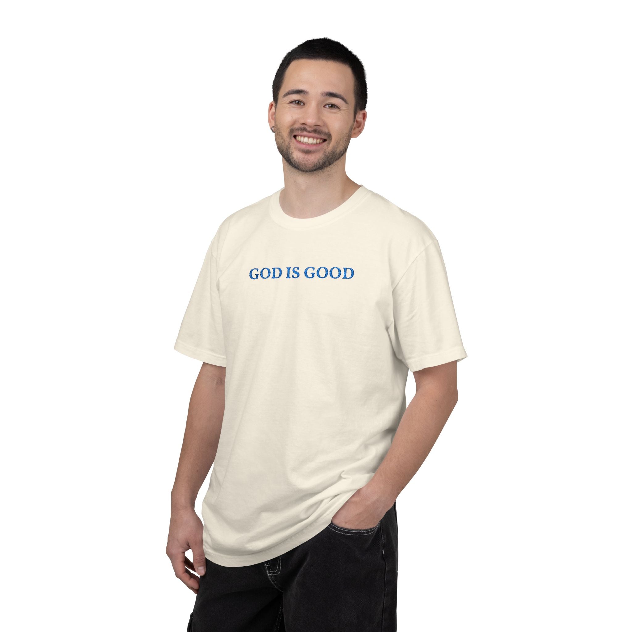 Smiling man wearing an Ivory Comfort Colors t-shirt with 'GOD IS GOOD' embroidered in cornflower blue thread