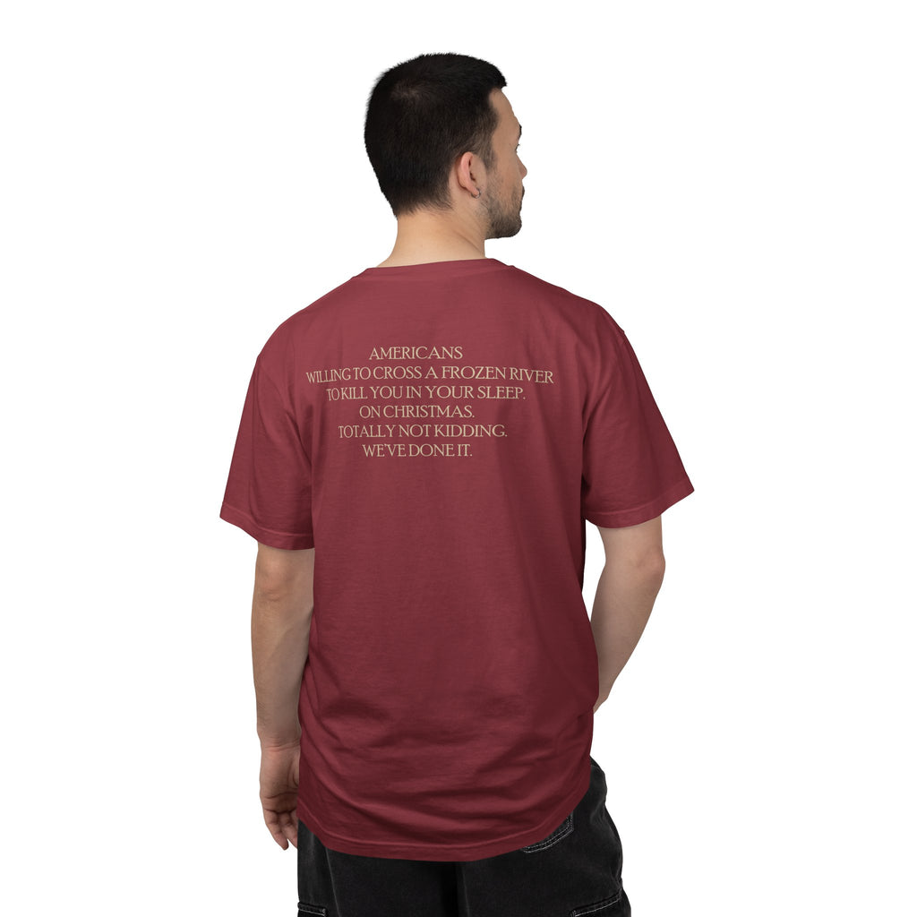 Back view of male model wearing America's First Christmas meme t-shirt with 'AMERICANS Willing to cross a frozen river to kill you in your sleep. On Christmas.' quote. Chili
