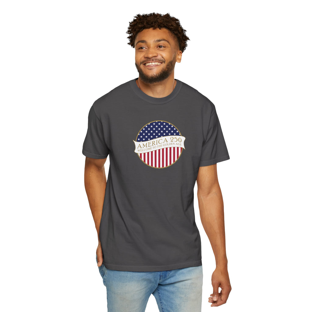Smiling man wearing a Graphite Comfort Colors t-shirt with an America 250 design with text 'America 250 Welcome to the Golden Age'