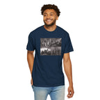 Smiling man wearing a True Navy Comfort Colors t-shirt printed with a montage of four revolutionary war era paintings