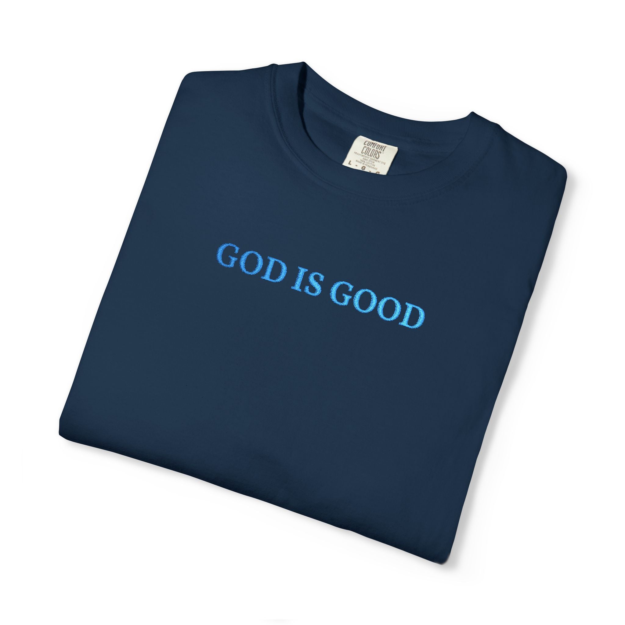 Folded True Navy t-shirt embroidered with 'GOD IS GOOD' in cornflower blue thread