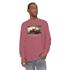 Man wearing a long-sleeve Crimson Comfort Colors t-shirt with Leutze's 'Washington Crossing the Delaware' with 'America's First Christmas December 25, 1776 printed below