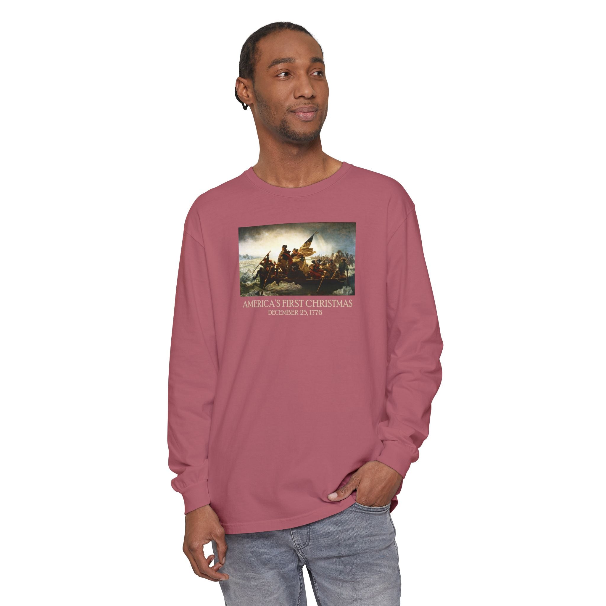 Man wearing a long-sleeve Crimson Comfort Colors t-shirt with Leutze's 'Washington Crossing the Delaware' with 'America's First Christmas December 25, 1776 printed below
