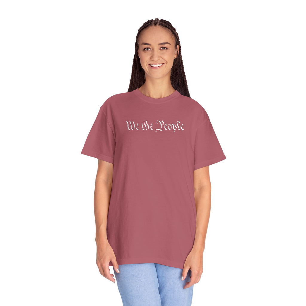 Smiling woman wearing oversized 'We the People' embroidered t-shirt in crimson