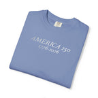 Folded Washed Denim Comfort Colors t-shirt with 'AMERICA 250 1776-2026' embroidered in white thread