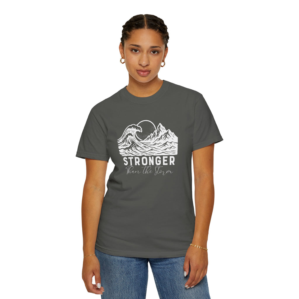 Person wearing Stronger Than The Storm faith t-shirt in Pepper