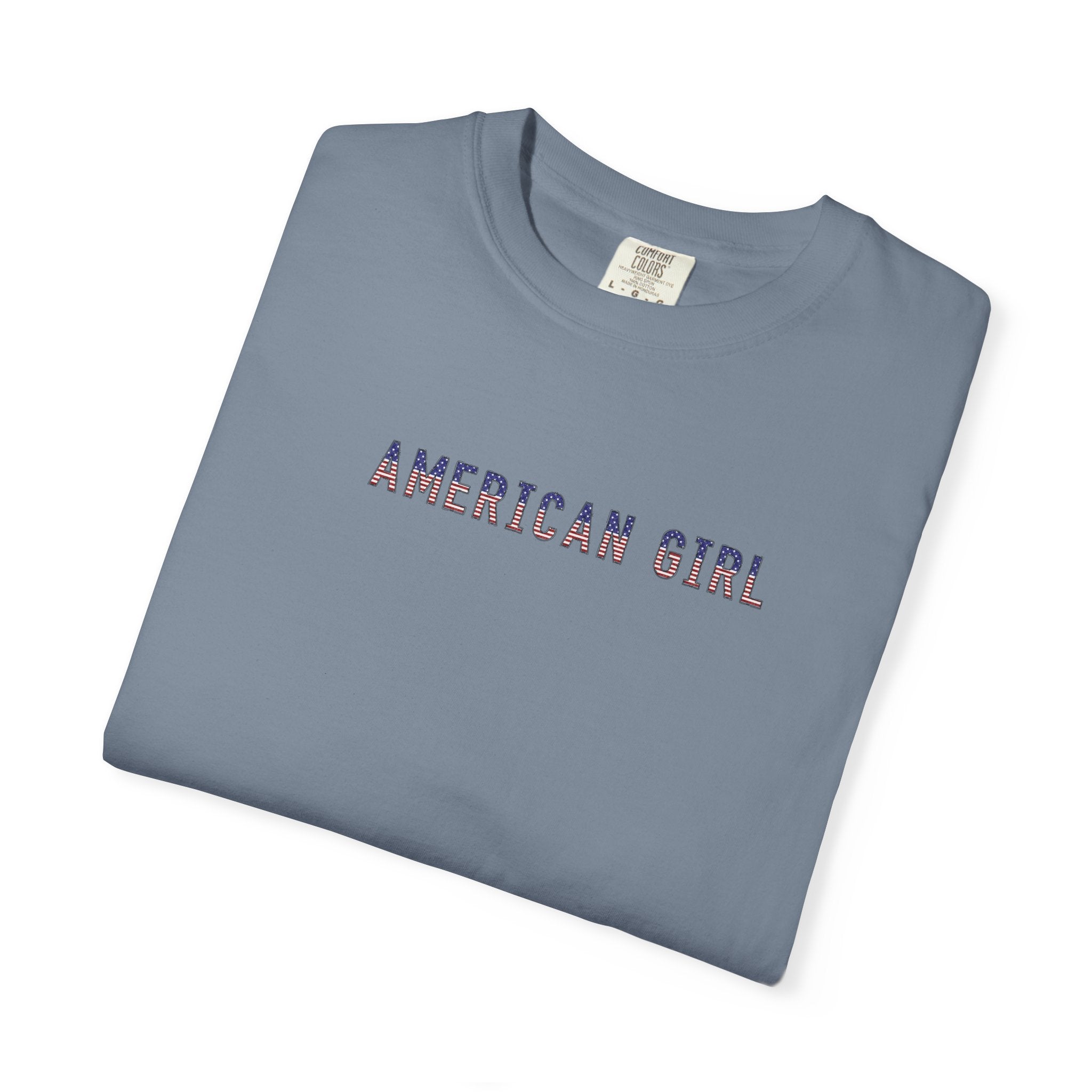 Folded blue jean-colored t-shirt with 'American Girl' in patriotic stars & stripes text