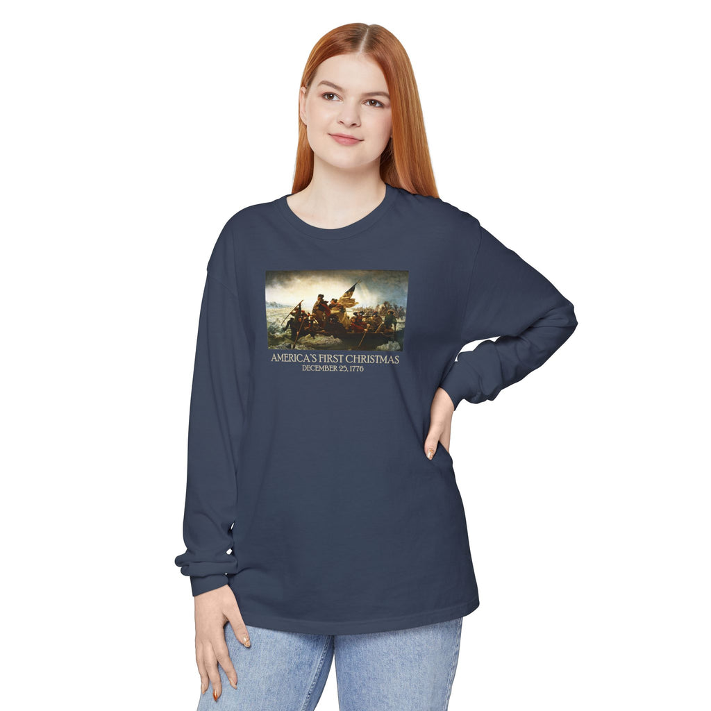 Woman wearing a long-sleeve Midnight Comfort Colors t-shirt with Leutze's 'Washington Crossing the Delaware' with 'America's First Christmas December 25, 1776 printed underneath