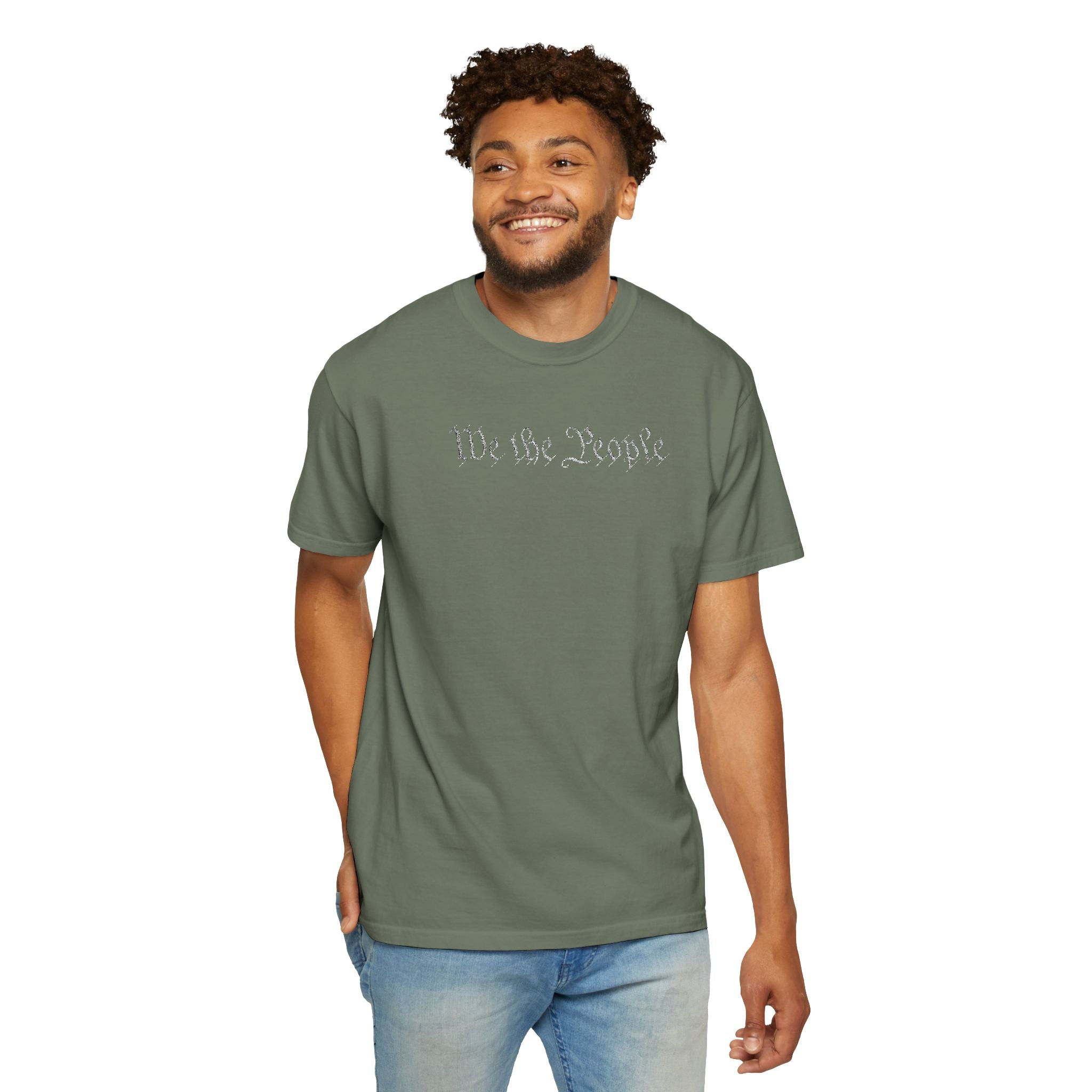 Smiling man wearing 'We the People' embroidered t-shirt in moss