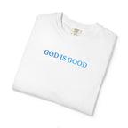 Folded White t-shirt embroidered with 'GOD IS GOOD' in cornflower blue thread