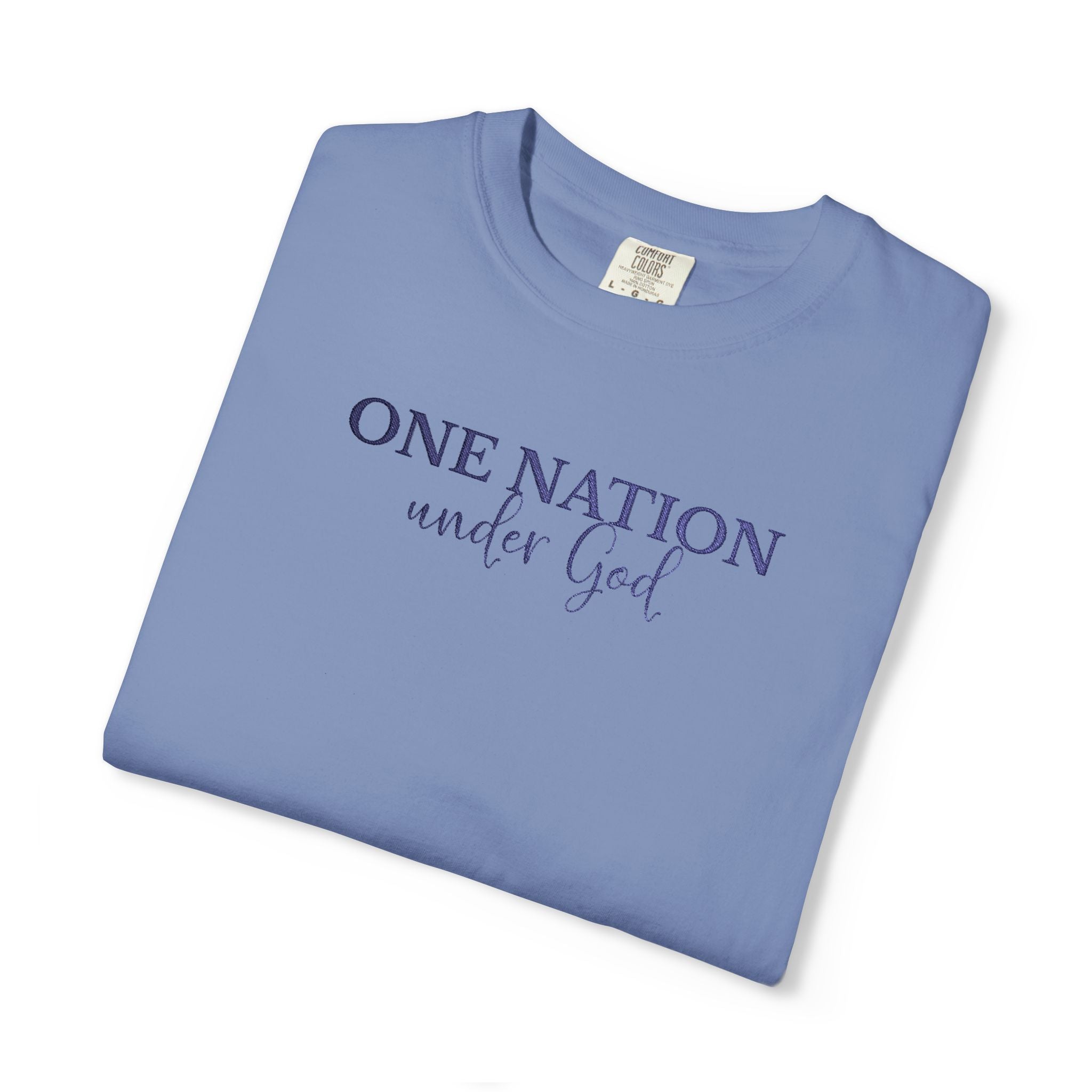 Folded Washed Denim Comfort Colors t-shirt with 'One Nation under God' embroidered with blue thread