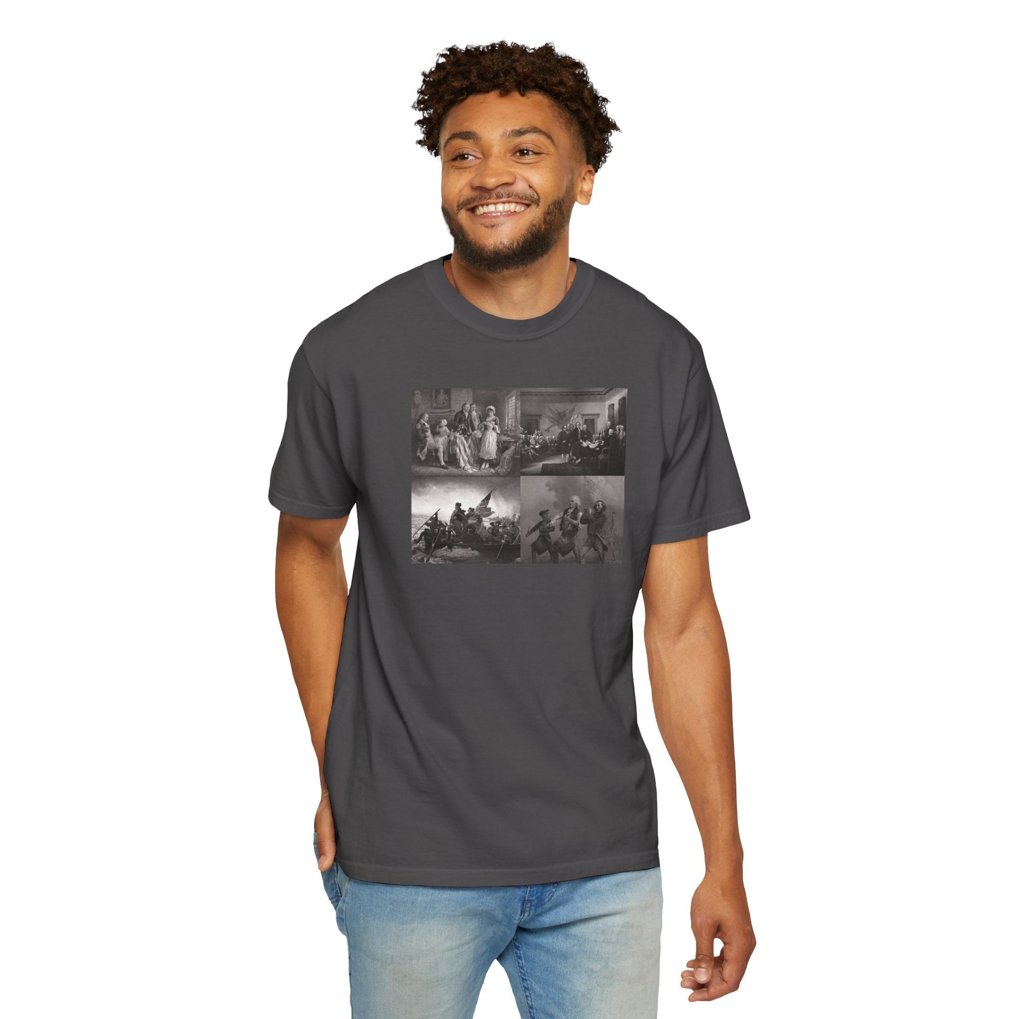 Smiling man wearing a Graphite Comfort Colors t-shirt printed with a montage of four revolutionary war era paintings