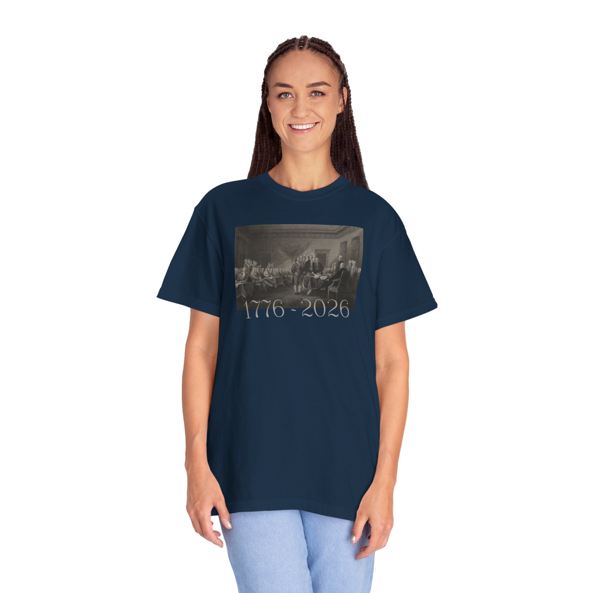 Woman wearing an oversized True Navy Comfort Colors t-shirt with a printed design of Trumbull's  'Declaration of Independence' painting with '1776-2026' in overlapping revolutionary era text