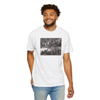 Smiling man wearing a White Comfort Colors t-shirt printed with a montage of four revolutionary war era paintings