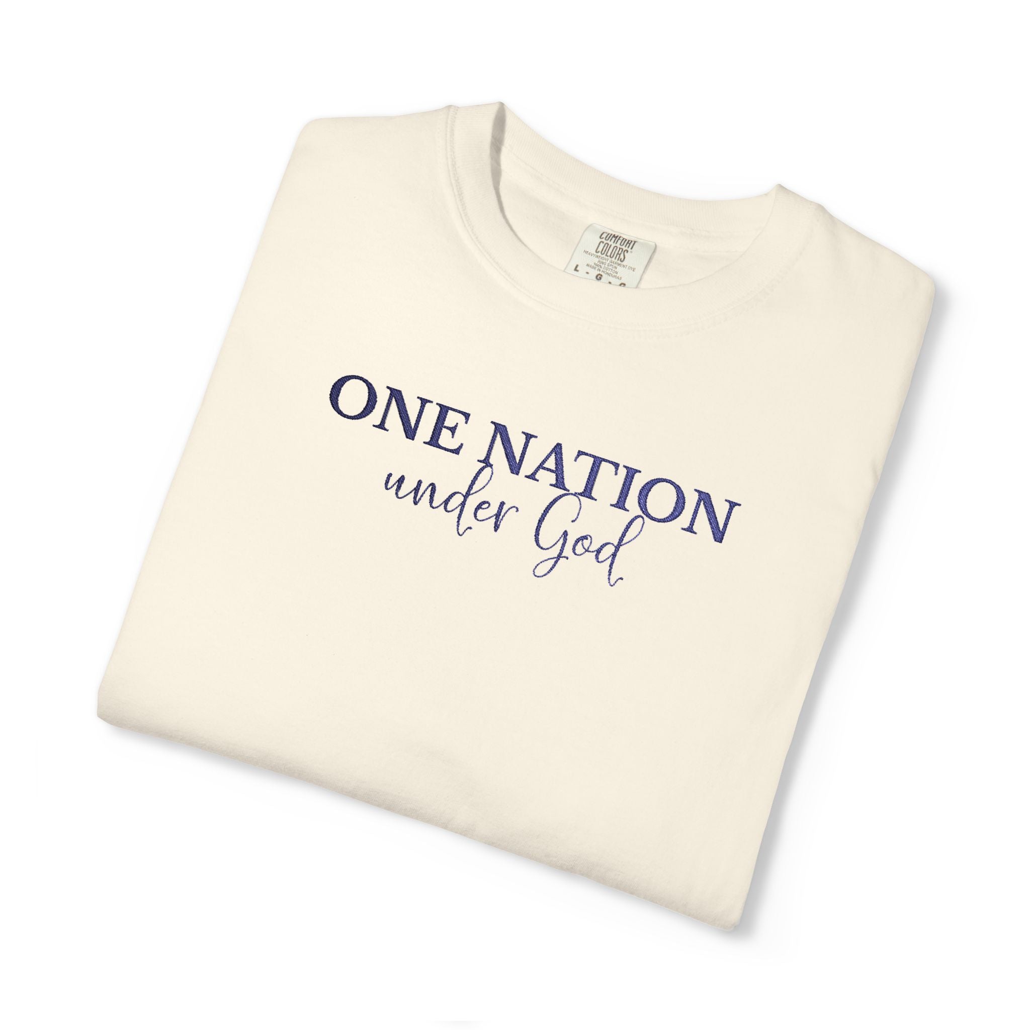 Folded Ivory Comfort Colors t-shirt with 'One Nation under God' embroidered with blue thread