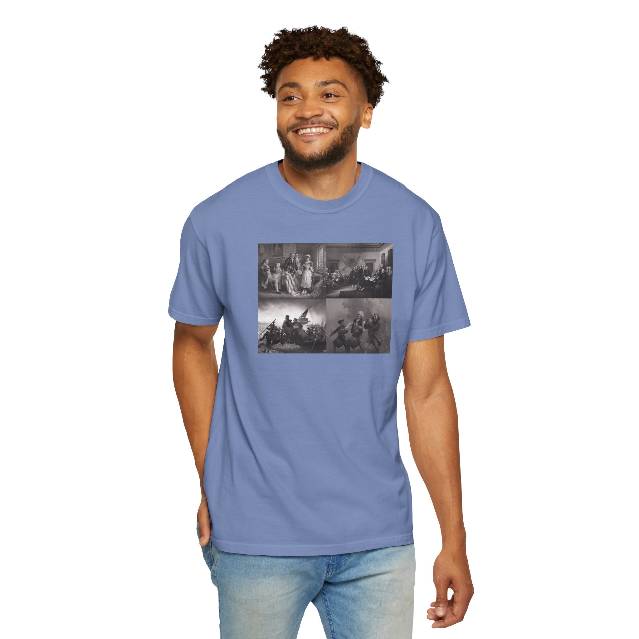 Smiling man wearing a Washed Denim Comfort Colors t-shirt printed with a montage of four revolutionary war era paintings