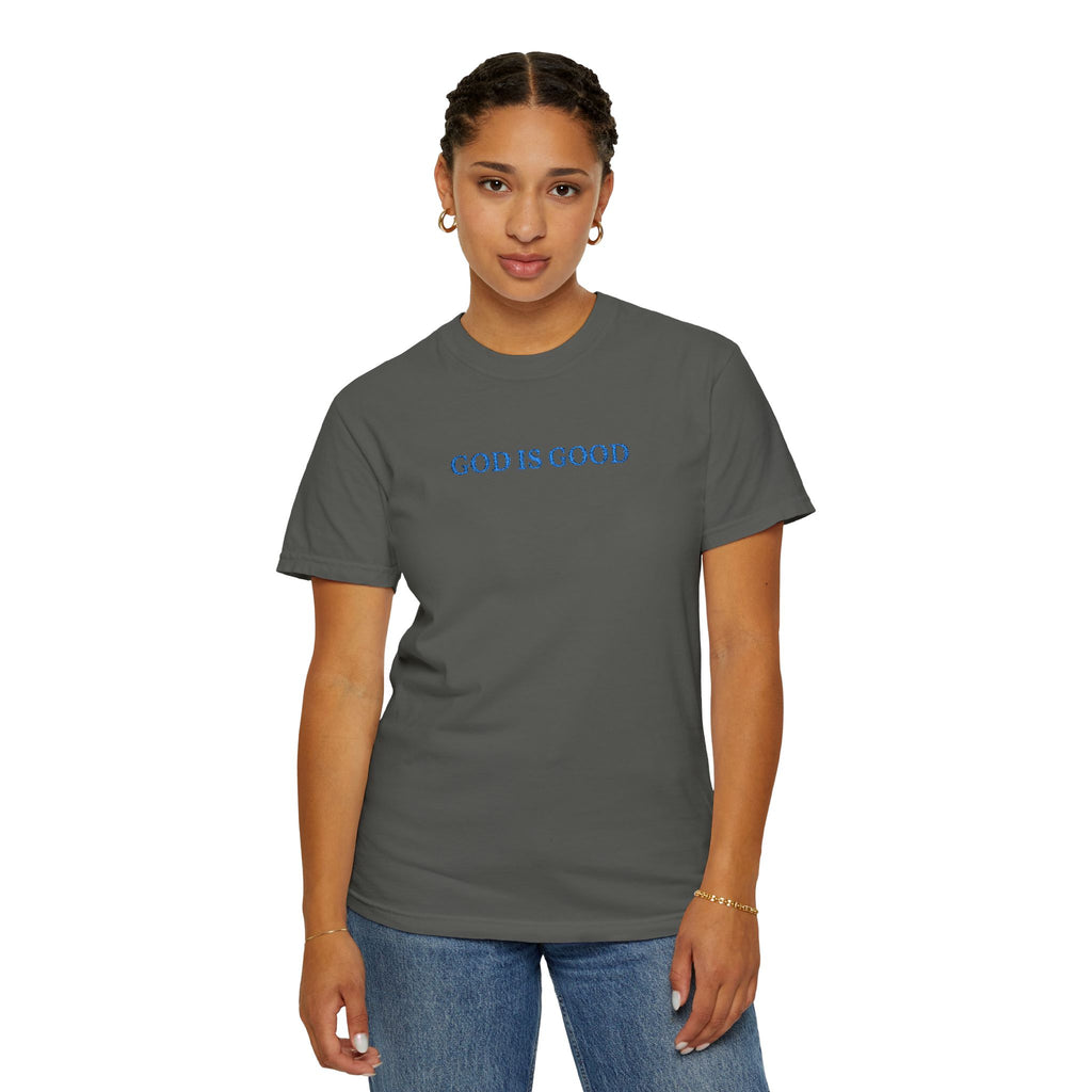 Woman wearing a Pepper Comfort Colors t-shirt embroidered with 'GOD IS GOOD' in cornflower blue thread
