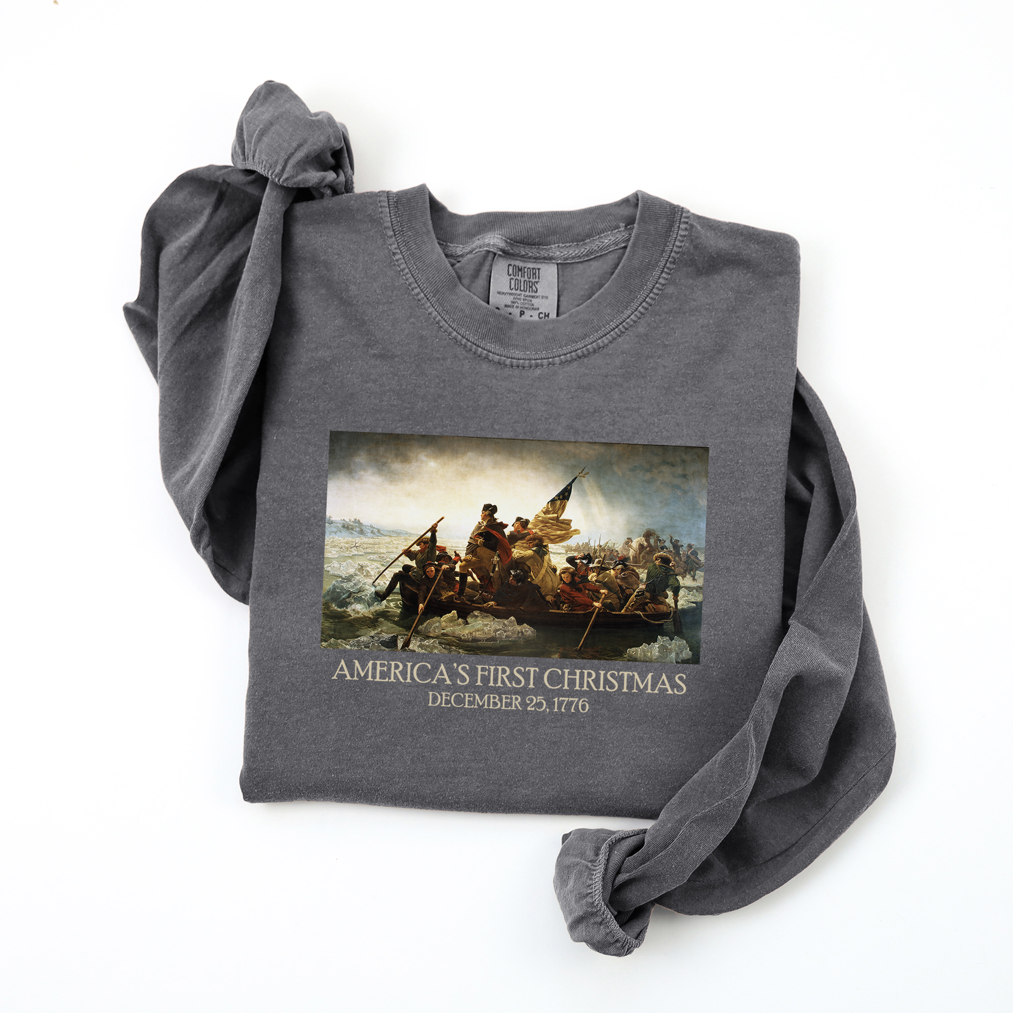 Folded long sleeve Pepper Comfort Colors t-shirt with Leutze's 'Washington Crossing the Delaware' and 'America's First Christmas December 25, 1776 printed beneath