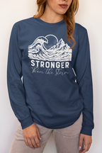 Woman wearing Stronger Than The Storm long sleeve faith t-shirt in Midnight