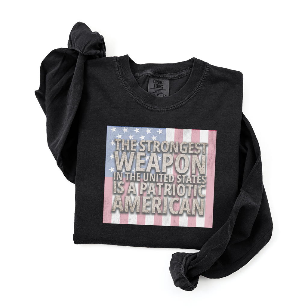 Folded 'Strongest Weapon is a Patriotic American' long sleeve t-shirt with distressed flag in black