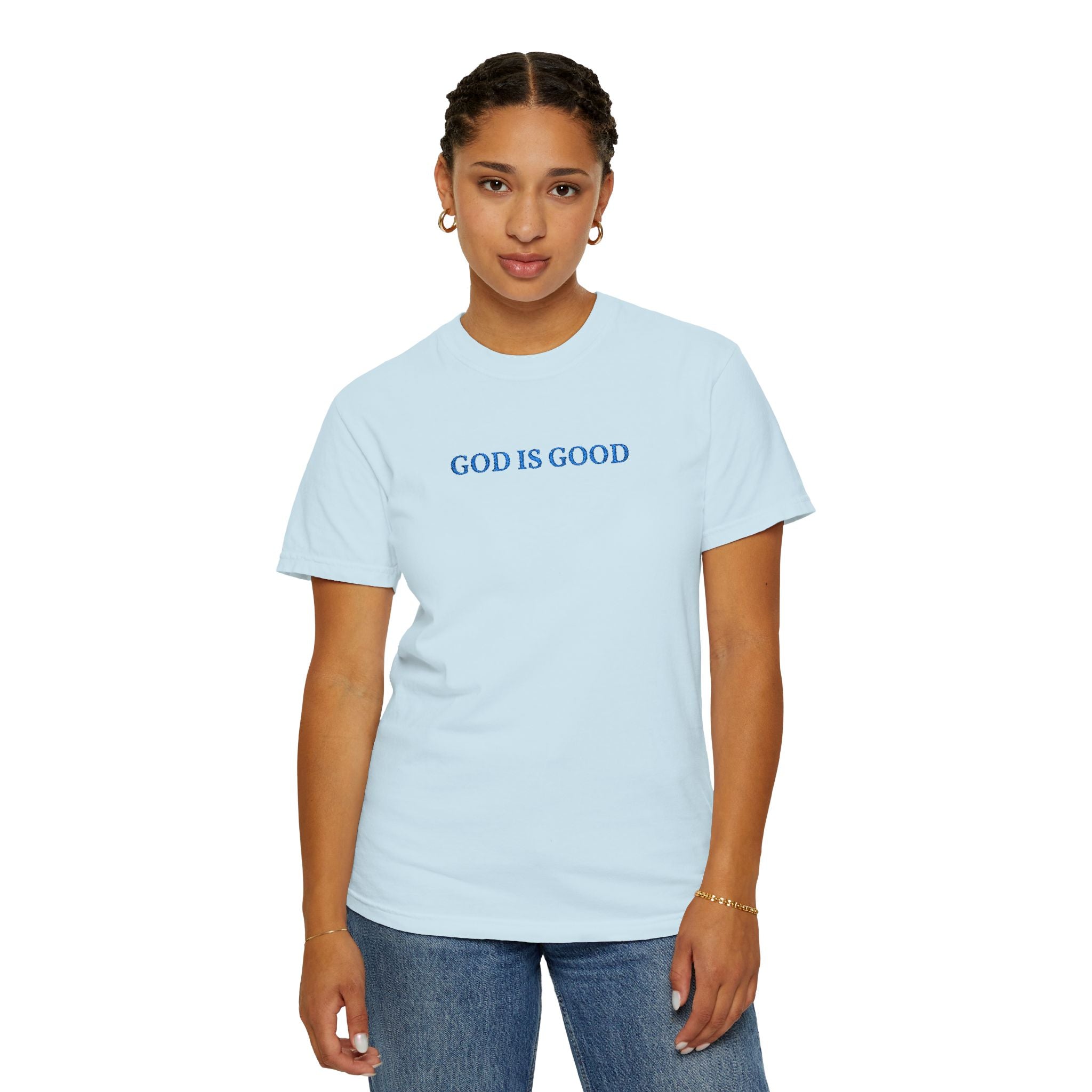 Woman wearing a Chambray Comfort Colors t-shirt embroidered with 'GOD IS GOOD' in cornflower blue thread