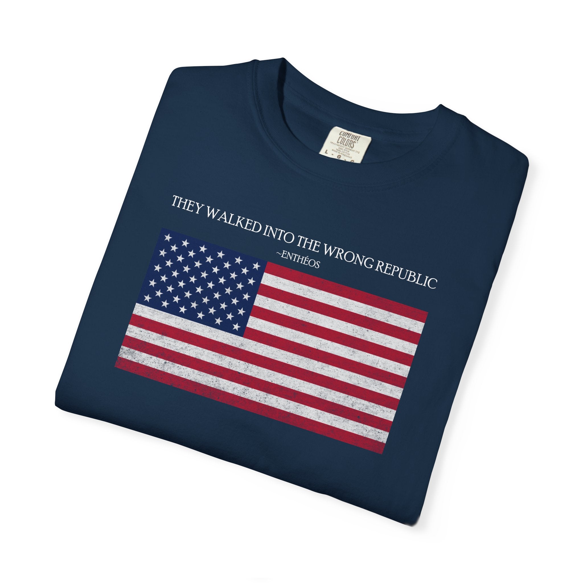 Folded True Navy Comfort Colors t-shirt with distressed American flag graphic and 'They Walked Into the Wrong Republic" quote from Entheos
