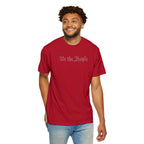 Smiling man wearing 'We the People' embroidered t-shirt in red
