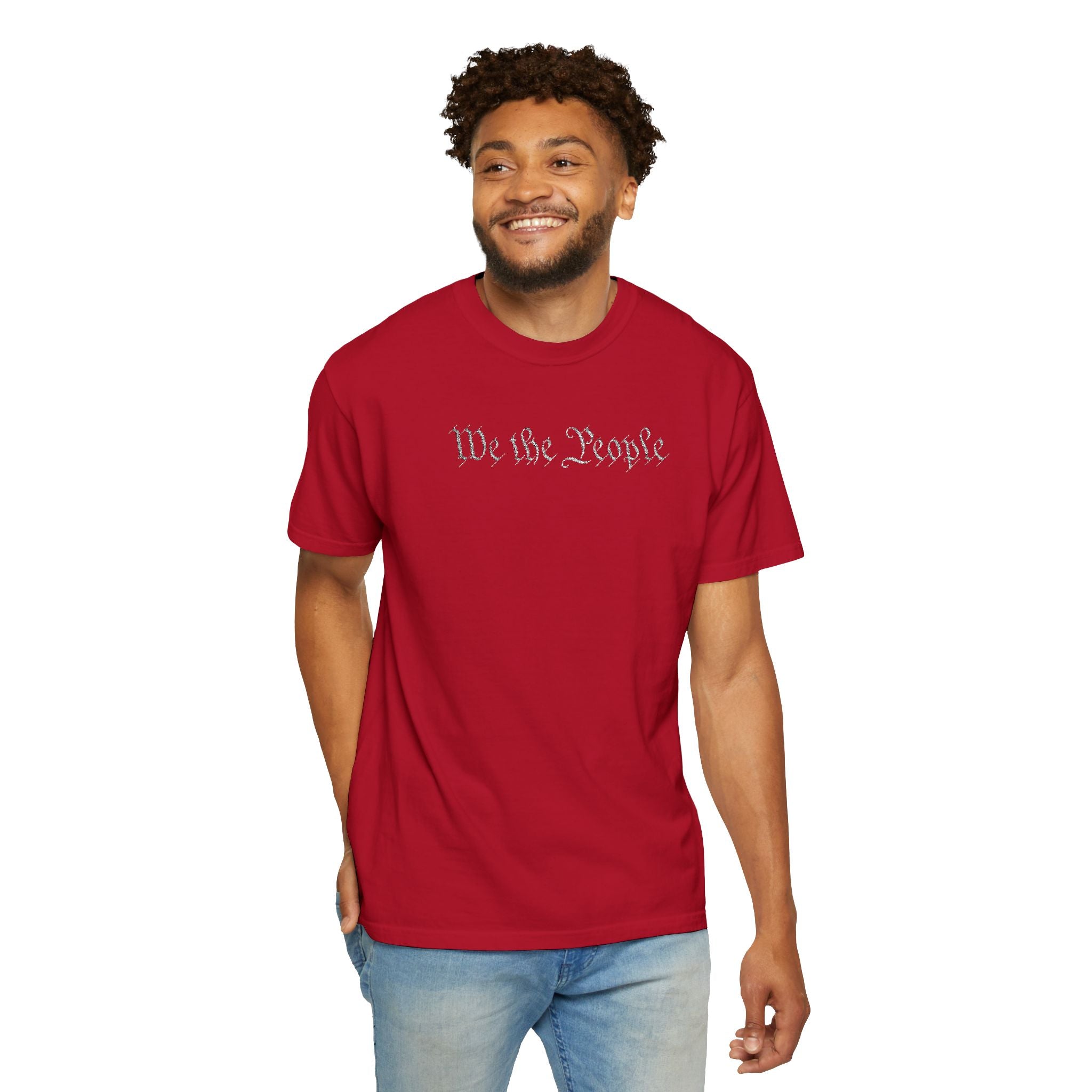 Smiling man wearing 'We the People' embroidered t-shirt in red