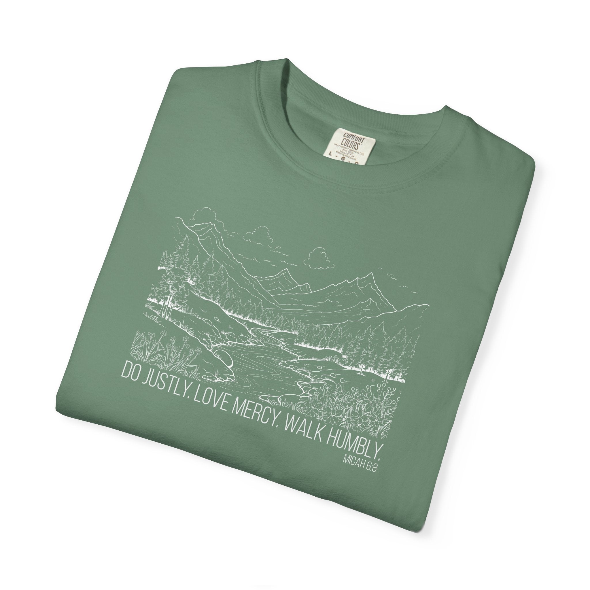 Folded Light Green Comfort Colors t-shirt with mountain river design and Bible verse from Micah 6:8