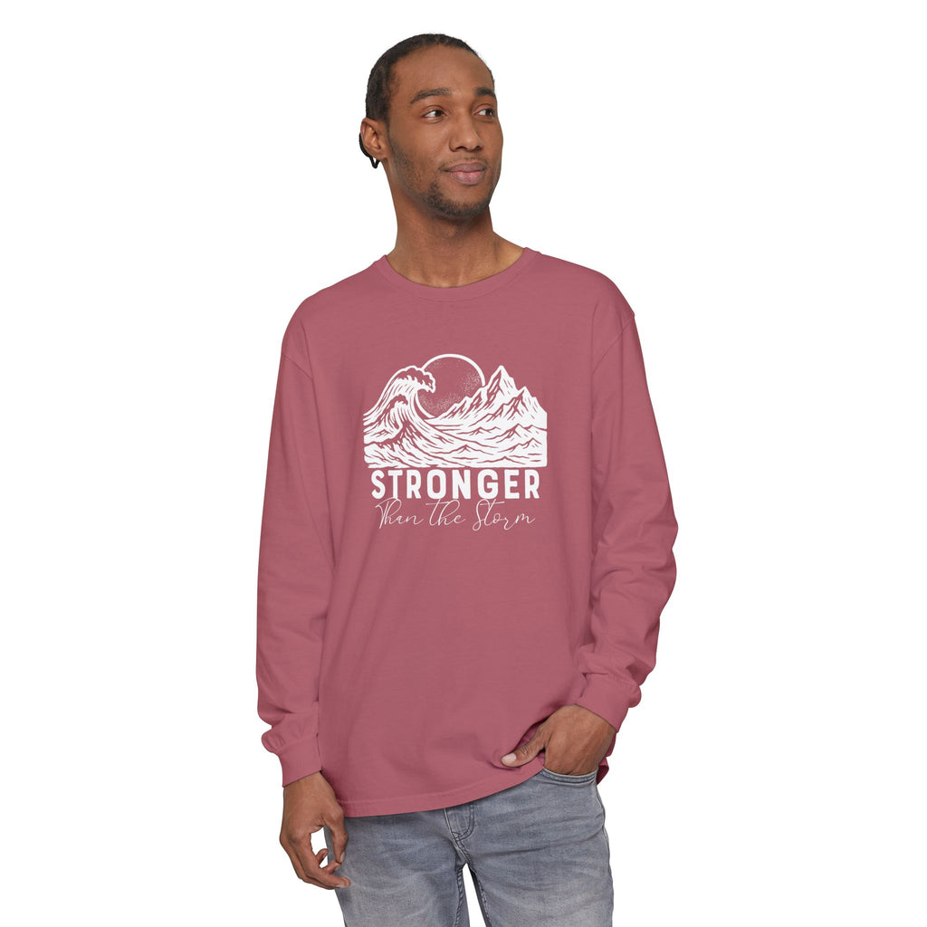 Male model in Stronger Than The Storm Christian long sleeve tee in crimson