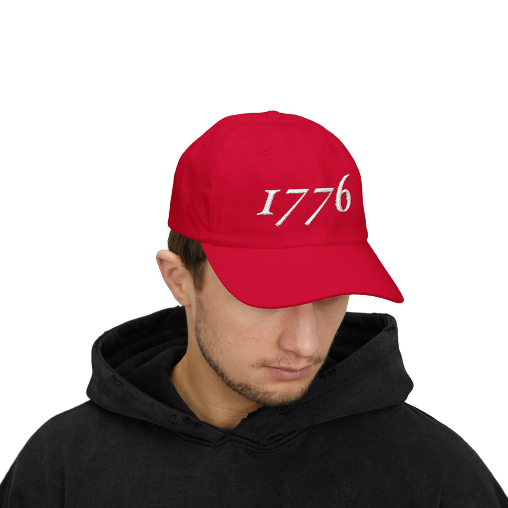 Man wearing a '1776' embroidered dad cap in cranberry
