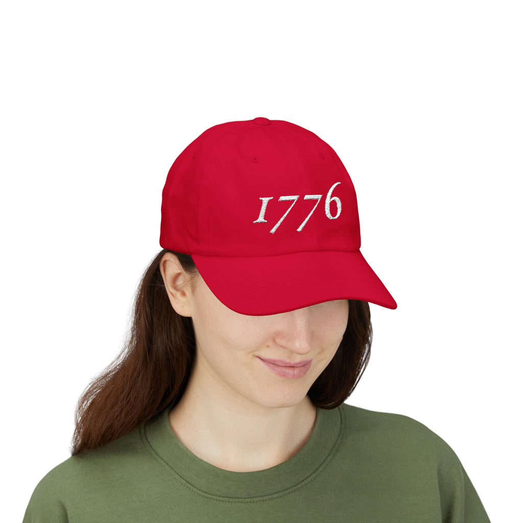 Front view of woman wearing a Cranberry dad cap embroidered with '1776'