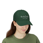 Woman wearing a spruce green cap with embroidered 'We the People 1776-2026' 