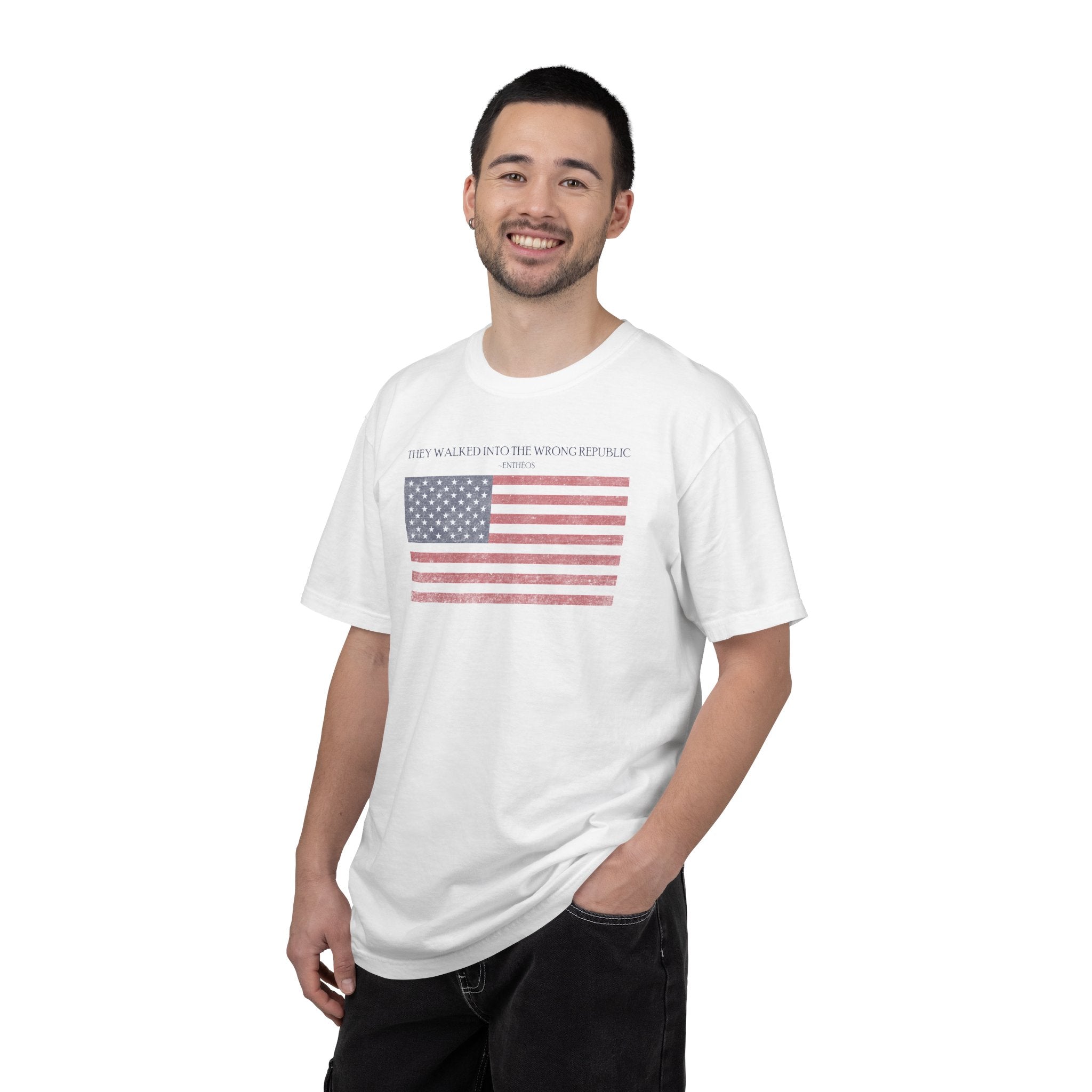 Smiling man wearing a White Comfort Colors t-shirt with distressed American flag graphic and 'They Walked Into the Wrong Republic' quote from Entheos
