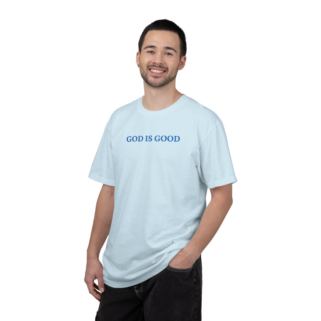Smiling man wearing a Chambray Comfort Colors t-shirt with 'GOD IS GOOD' embroidered in cornflower blue thread